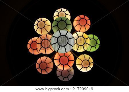The street lamp in the form of bunches of different colors of round form.