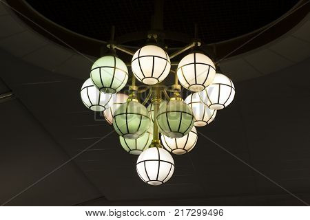 The street lamp in the form of bunches of different colors of round form.