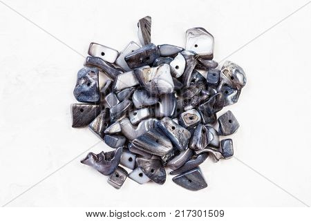 top view of beads from natural nacre stones on gray concrete background