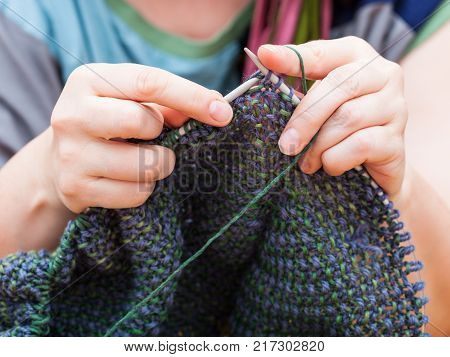 Knitter Knits Pullover From Wool