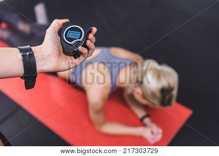 young sportive woman doing hyperextension exercise on gym machine