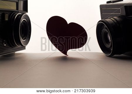 Love heart and cameras . Love photo or oter love aim concept on white background