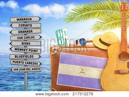 Concept of summer traveling with old suitcase and Nicaragua town sign