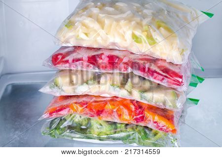 Frozen vegetables in bags in refrigerator. Freezing.