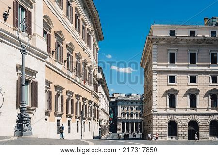 Rome, Italy - August 24, 2016: View of Piazza di Monte Citorio in historical city centre of Rome against blue sky