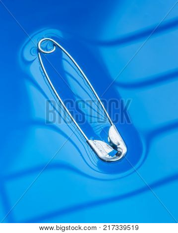 Physical experiment - pin floating on water surface.