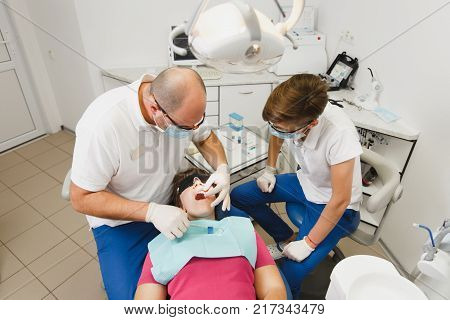 Process Of Preparing And Installing Dental Ceramic Crown. Professional Dentist And Assistant, Lookin