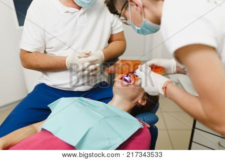 Process Of Preparing And Installing Dental Ceramic Crown. Professional Dentist And Assistant, Lookin