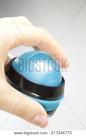 Woman hand holding rollon ball for relaxing body massage