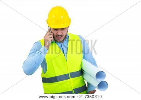 Angry upset young construction engineer yeling at the phone.