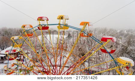 Ferris wheel in the central park of the city in winter. Aerial view.