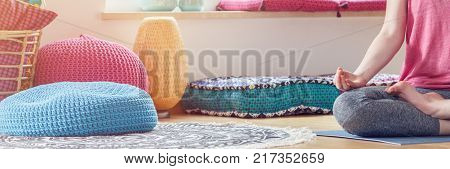 Poufs Next To Meditating Person