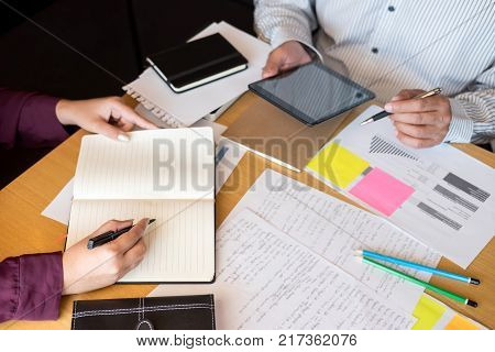 Education teaching learning technology and people concept. Two high school students or classmates with helps friend catching up workbook learning in classroom Tutor book with friends.