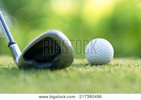 Golf club hitting golf ball along fairway towards green with copy space green nature background. Lifestyle Concept. select focus