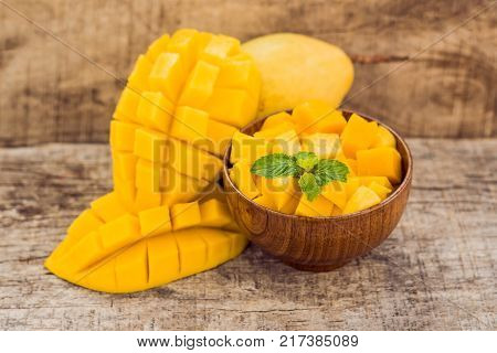 Mango Fruit And Mango Cubes On The Wooden Table