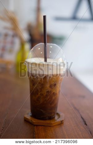 Tasty cold refreshing drink with coffee milk and ice in glass