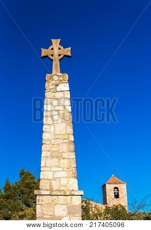 Memorial Cross And Church Of Santa Maria De Siurana In Siurana De Prades Tarragona Spain. Copy Space