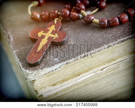 An ancient rosary on an old book