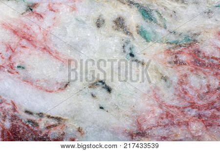 grey and red listvenite mineral texture closeup