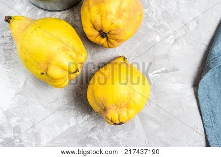 Close-up detail of ripe quince fruits on kitchen counter top.