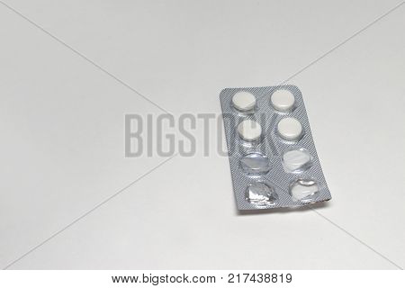 cut into a half transparent packaging of white tablets antibiotic