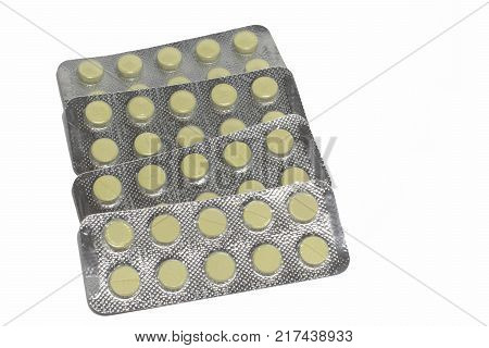 set of blister packs with the yellow tablets inside. isolated