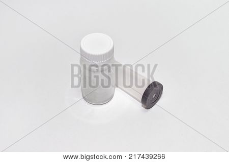 plastic containers: jar for tablets with screw cap and test tube with black lid with hole