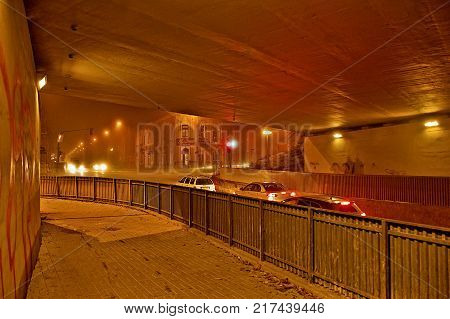 Chomutov Czech republic - November 23 2017: waiting cars under bridge by intersection on between Blatenska street Moravska street and Roosevelt street during foggy autumnal evening