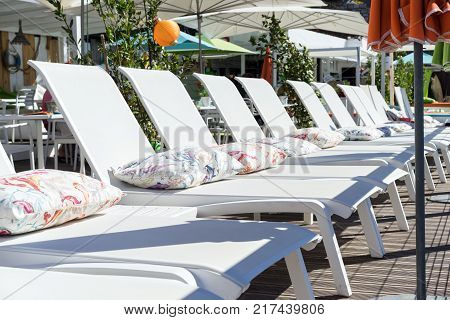 terrace in cafe on the beach with daybed and umbrellas