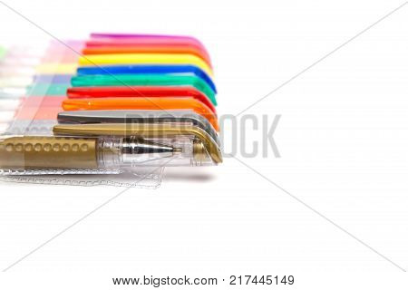 A set colored pens on a white background