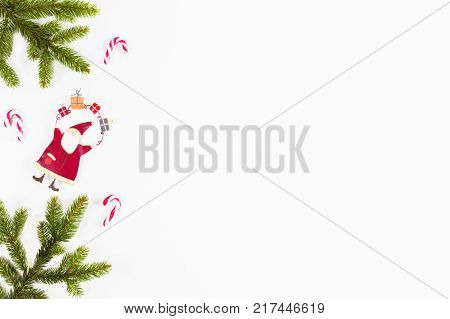 Christmas background with fir branches, pine cones and Xmas decoration on white background.