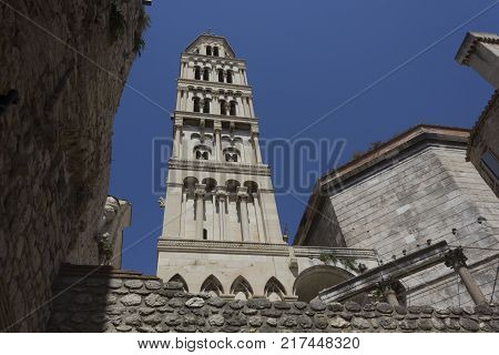 SPLIT, CROATIA - AUGUST 11 2017: Looking up at Saint Domnius bell tower in Split with Split fortified walls around