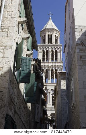 SPLIT, CROATIA - AUGUST 11 2017: Architectural view of Saint Domnius bell tower through buildings windows