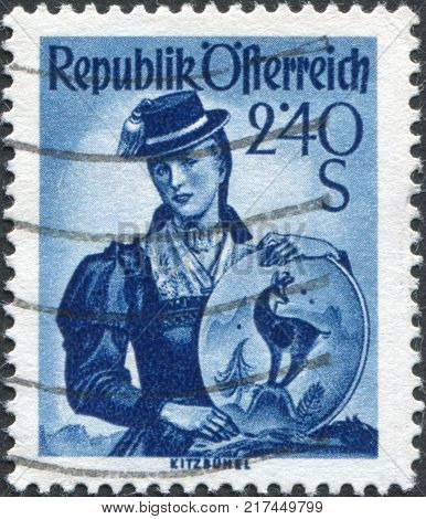 AUSTRIA - CIRCA 1951: A stamp printed in Austria shows a woman in national dress Tyrol Kitzbuhel circa 1951