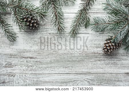 Christmas background with fir tree and decoration on dark wooden board. Flat lay, top view. Christmas, New Year's composition with copy space for text.
