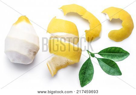Peeled lemon and lemon zest on white background. Close-up.