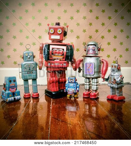  A family of retro robot toys on old woden floot with reflection