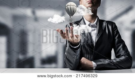 Closeup of business woman in suit presenting flying aerostate among clouds in her palm with office view on background. 3D rendering.