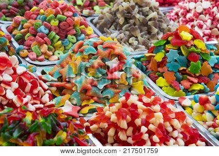 Assortment of jellied colored sweets as a product background