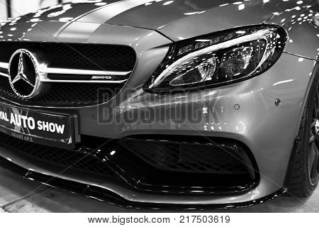 Sankt-Petersburg Russia July 21 2017: Front view of a Mercedes Benz C 63s AMG coupe 2017. Front Headlight. Dark Matt colour .Car exterior details. Black and white. Photo Taken at Royal Auto Show July 21