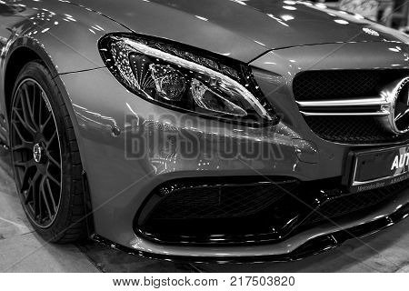 Sankt-Petersburg Russia July 21 2017: Front view of a Mercedes Benz C 63s AMG coupe 2017. Front Headlight. Dark Matt colour .Car exterior details. Black and white. Photo Taken at Royal Auto Show July 21