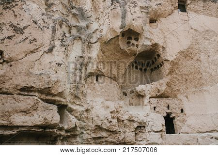 Holes in the mountains of Cappadocia in the form of windows. Inside the mountains there is a dwelling of ancient people who lived many millions of years ago. Now it's empty