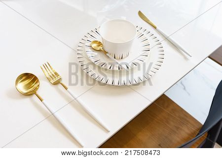 wooden table in dining room with elegant table setting