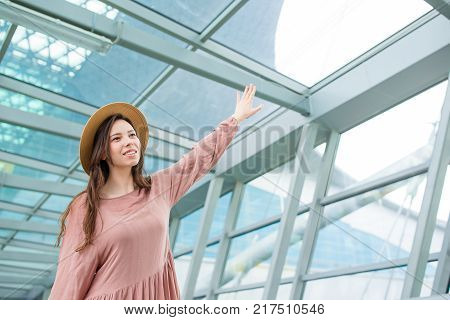 Young woman in international airport walking with her luggage.
