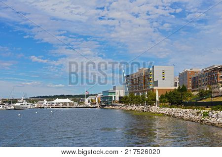 OXON HILL MARYLAND USA - SEPTEMBER 11 2016: National Harbor waterfront panorama with flags at half-staff to honor the nearly three thousand lives lost on that very day fifteen years ago.