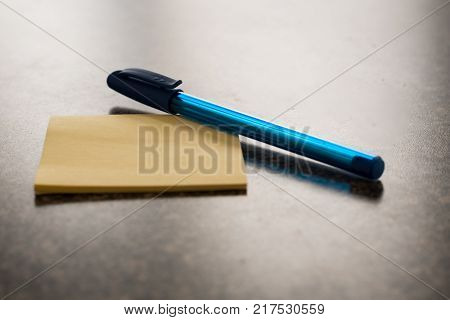 Sticky note with pen on it to take messages, notes and to-do lists