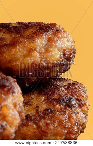 Fried chops with a crisp on a yellow background