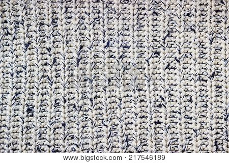 Knitted background. Knitted texture. A sample of knitting from wool. Knitting Pattern.