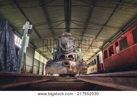 Front View of an Old Steam Locomotive Standing in the Depo