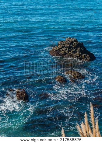 Rocks sticking out of the water in the ocean